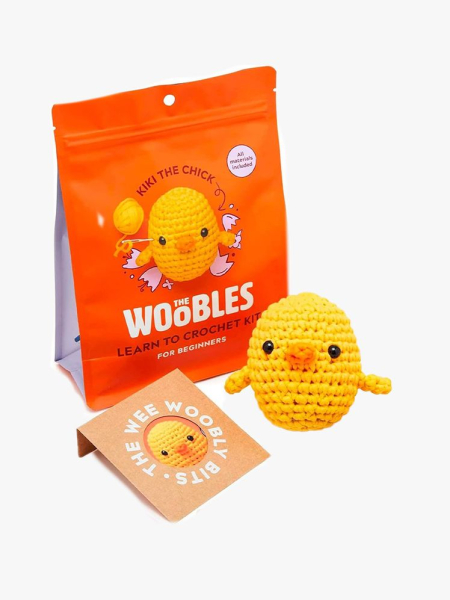 The Woobles Beginners Crochet Kit orange bag and crochet yellow duck on gray background