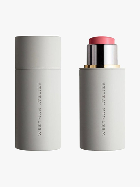 Westman Atelier Baby Cheeks Lip + Cheek Cream Blush Stick: An unopened gray tube (left) and an opened gray tube (right) filled with light pink cream blush stick on a light gray background