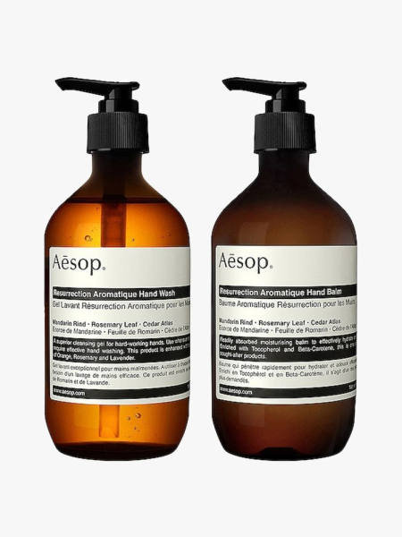 Aesop Resurrection Duet two brown pump bottles of soap with black and white striped labels on light gray background